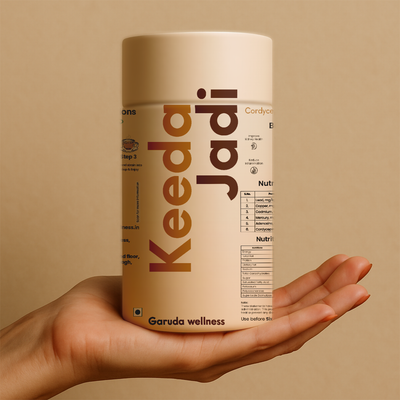 Hand holding a container of Keeda Jadi  with a beige background. Product avaliable in Dheradun.
